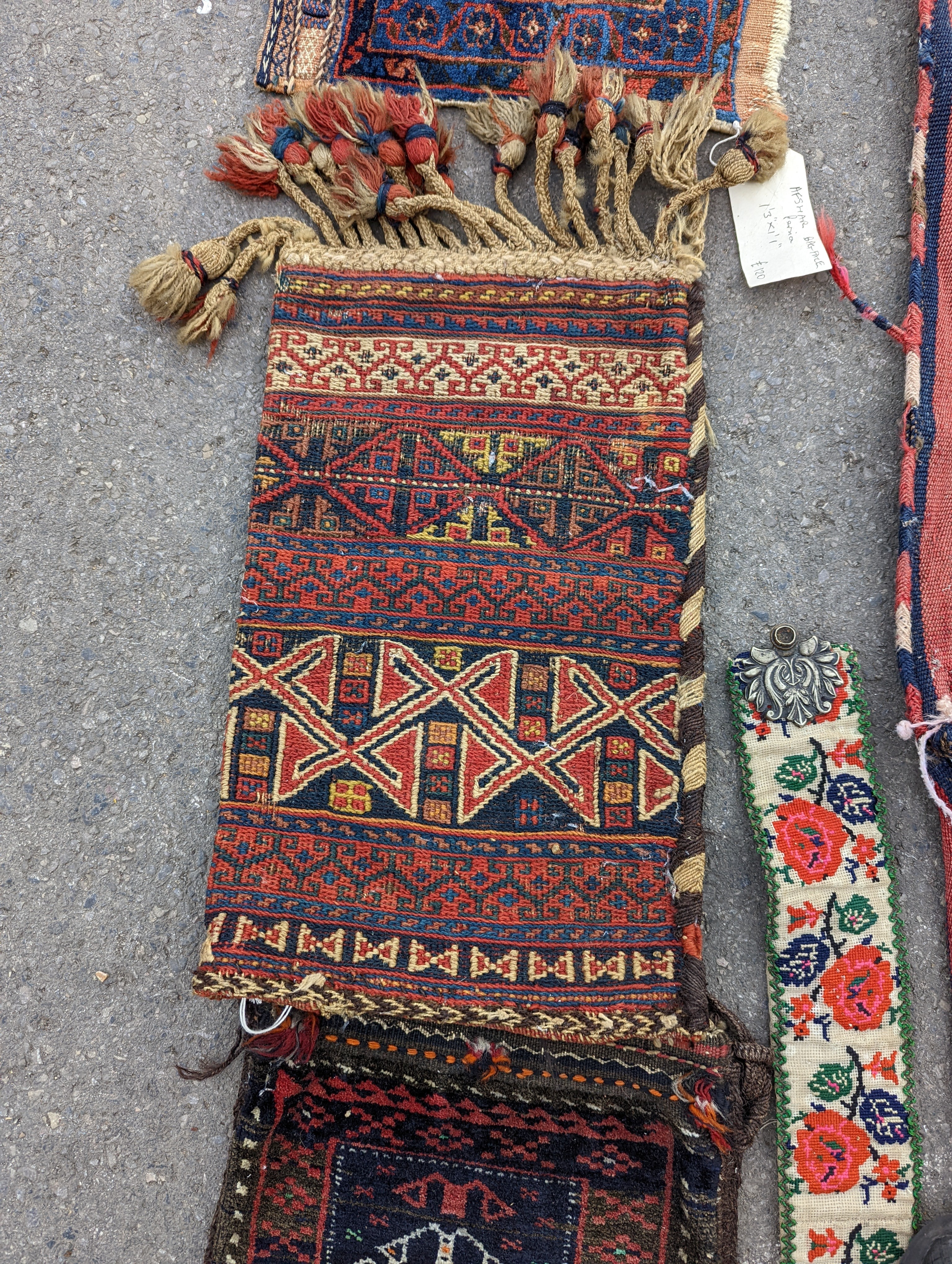An Afghan Kilim flatweave saddlebag, 144 x 69cm together with six assorted bags, faces, etc.